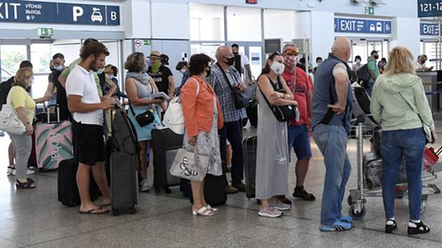 Cestující čekají na odbavení 1. července 2020 v hale Letiště Václava Havla v Praze