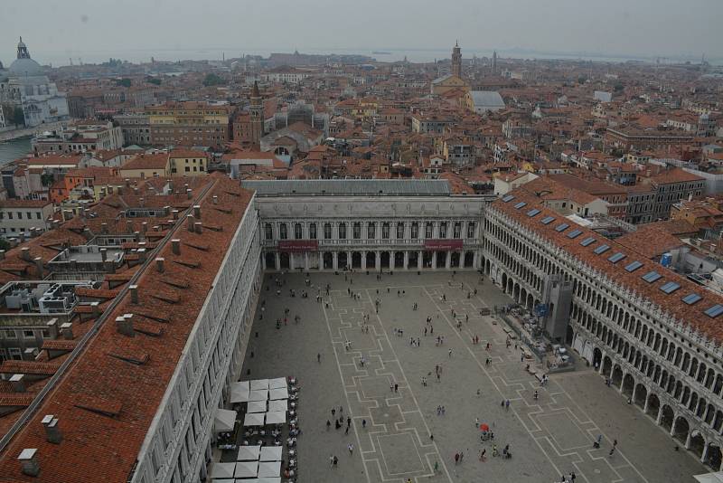 Náměstí svatého Marka je lemováno několika budovami. Kromě Dóžecího paláce, Baziliky svatého Marka a Kampanily (na snímku nejsou vidět), jde o komplex tří budov - Procuratie Nuove (vlevo), Ala Napoleonica (uprostřed) a Procuratie Vecchie (vpravo).