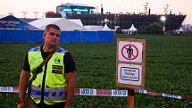 Úrodu na polích přiléhajících k festivalovému areálu před pošlapáním chránili policisté.