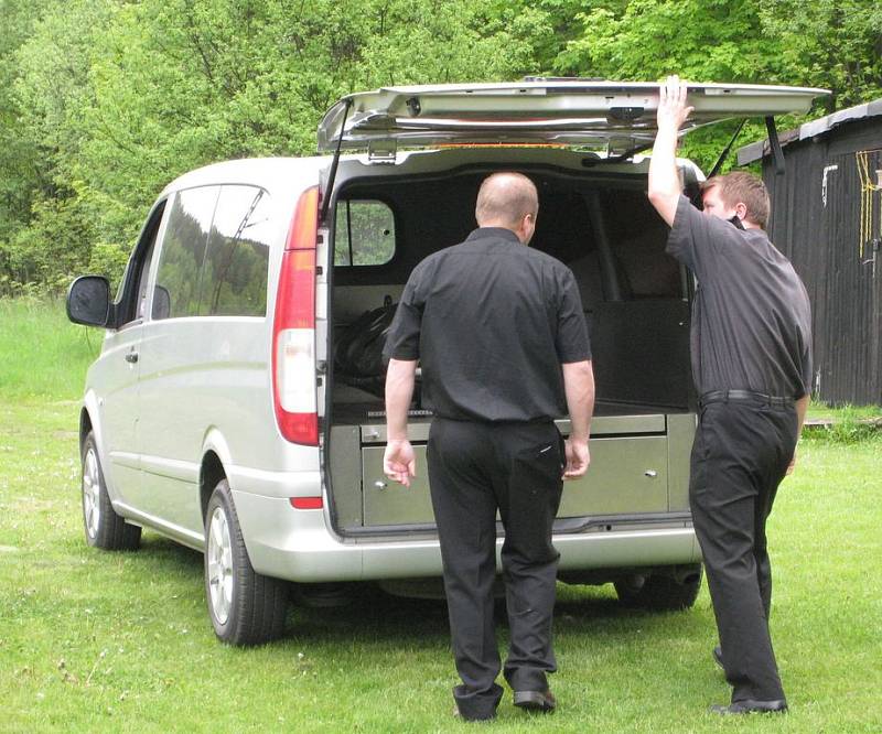 Pracovníci pohřební služby odvážejí tělo fanouška z místa tragédie.