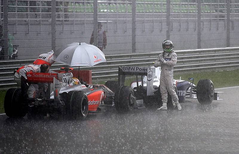 Nick Heidfeld z BMW Sauberu (vpravo) a Lewis Hamiton v McLarenu po přerušení závodu v Malajsii.