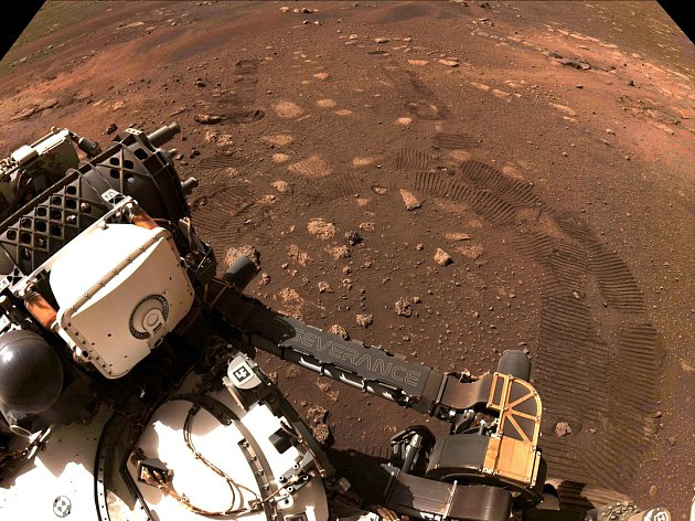 Trvalý záznam, 4. března 2021. Stopy pásů zůstaly ve vyprahlé hlíně kráteru Jezero na okraji prolákliny Syrtis Major na Marsu. Snímek je z prvního výjezdu americké sondy Perseverance
