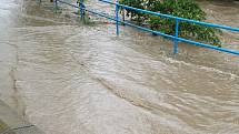Rozvodněný potok Rokytenka ve vsetínské místní části Rokytnice.