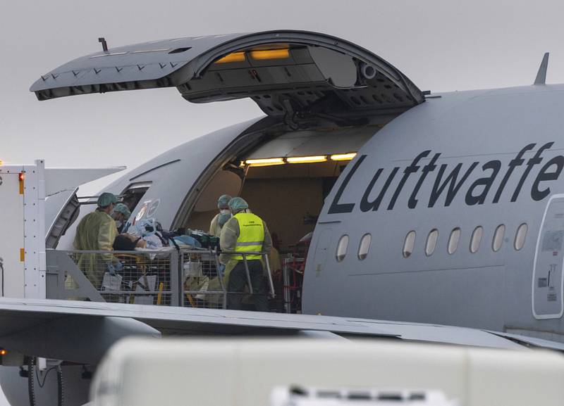 Pacienta s onemocněním covid-19 nakládají do letadla německého armádního letounu na letišti v Memmingenu 26. listopadu 2021