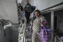 Těhotná žena utíka z porodnice v Mariupolu, kterou zasáhlo ruské bombardování.