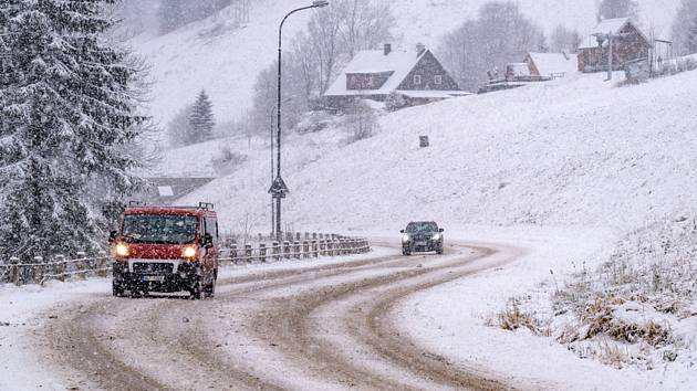 Automobily projíždějí po zasněžené silnici ve Velké Úpě v Krkonoších, 21. listopadu 2022, Trutnovsko.