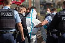 Němečtí policisté s mužem podezřelým z toho, že ve vlaku na západě Německa pobodal tři lidi, 13. května 2022