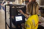 They carry boxes with shoes or fashion accessories.  Robots help pick orders from Leder & Schuh e-shop customers in South Moravian Pohořelice