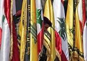 Členové Hizballáhu drží vlajky Libanonu a svého hnutí