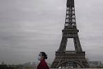 Žena s rouškou a Eiffelova věž. Ilustrační snímek