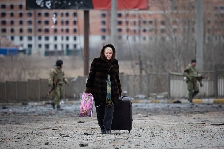 Ukrajinská žena prchá před válkou. 