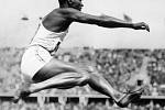 Legendární americký atlet Jesse Owens zachycen při skoku do dálky na olympiádě v Berlíně v roce 1936. Za svůj skok získal Owens jednu ze čtyř zlatých medailí, které si z Berlína odvezl.