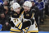 Hokejista Bostonu Pavel Zacha (vpravo) se raduje ze svého gólu se svým spoluhráčem Taylorem Hallem v utkání NHL na ledě Toronta 2. února 2023