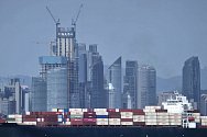 Obchodní kontejnerová loď míjí mrakodrapy v čínském městě Čching-tao. Ilustrační foto