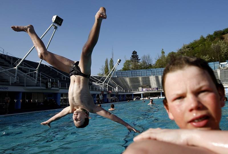 I na jaře řádí děti ve venkovním plaveckém bazénu v pražském Podolí. Umožňují jim to letní teploty, které v dubnu panují.