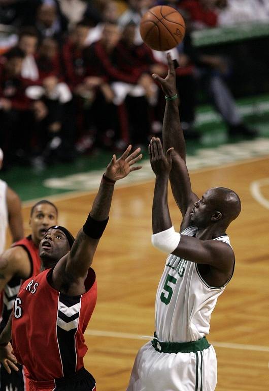 Kevin Garnett se prosazuje přes obranu Toronta.