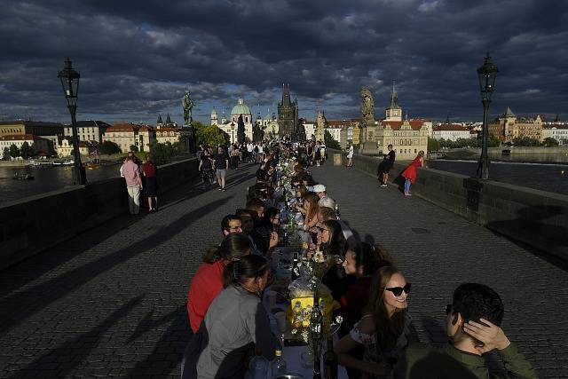 Netradiční hostina u půlkilometrového stolu přímo na Karlově mostě 30. června 2020 večer symbolicky ukončila koronavirovou dobu a ukázala oživení historického centra Prahy.