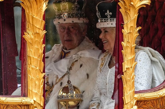 Britský král Karel III. a královna Camilla po korunovační ceremonii ve zlatém státním kočáře.
