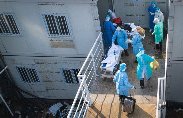 Zdravotníci ve Wu-chanu převážejí pacienta s koronavirem.
