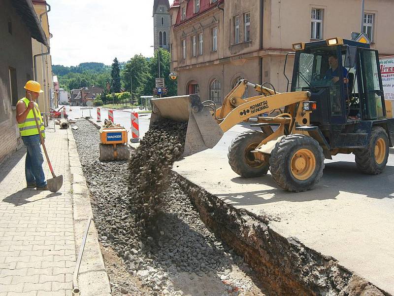 BUDOVÁNÍ KANALIZACE. Na dvanáct set metrů dlouhém úseku silnice I/10 ve Velkých Hamrech v současné době budují splaškovou kanalizaci. Dopravu na zúžené silnici kyvadlově řídí semafory. Část úseku bude možná v srpnu uzavřena úplně.