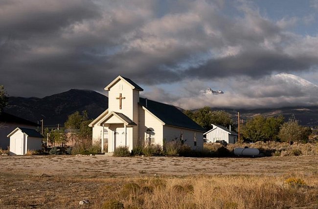 Temné mraky letí nad kostelem ve vesnici Baker v Nevadě, poblíž hranice s Utahem.