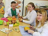 Studentky žatecké školy pod dohledem lektora Luďka Procházky připravují dekorace z vyřezávaného ovoce. 