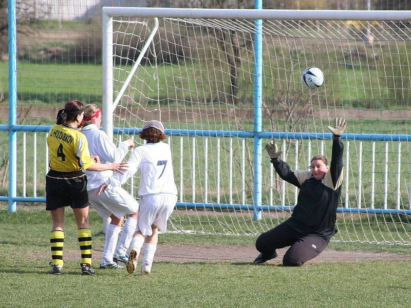 Bezmocná brankářka se snaží dosáhnout na střelu.