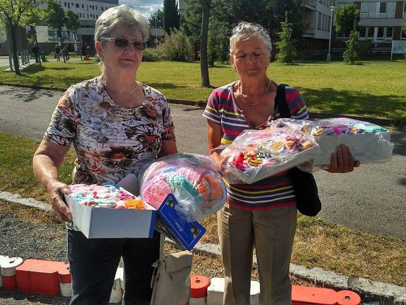 Heda Papežová a Alena Pitrová odvezly do FN v Plzni zásoby rukaviček, čepiček a ponožek pro nedonošená miminka, které napletly během roku kdyňské ženy.