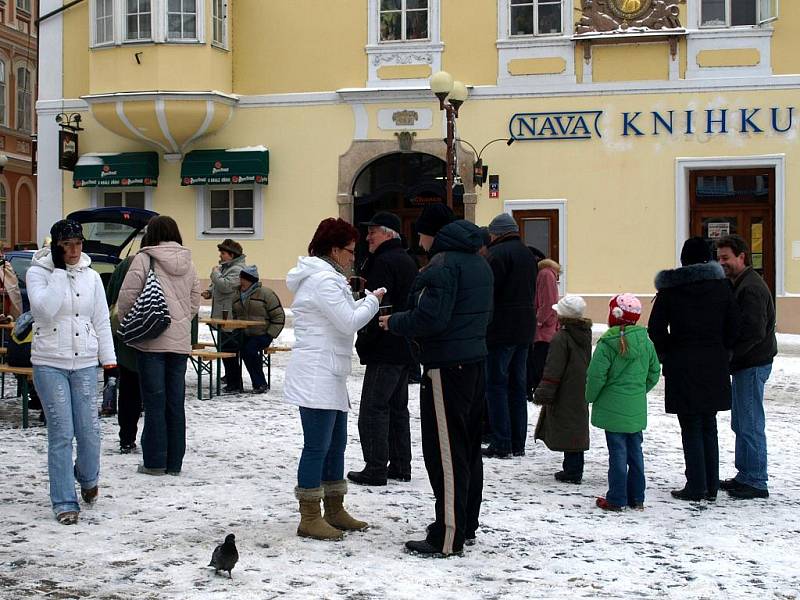 KOLEDNÍCI při 'starostově' polévce na chebském náměstí zpívali koledy. Na kytaru je doprovázel farář Petr Hruška. 