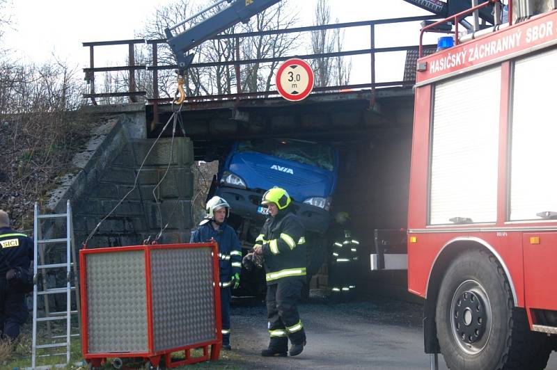 Nepříjemné překvapení čekalo včera na řidiče nákladního vozidla při projíždění pod železničním viaduktem v Nebanicích na Chebsku. Šofér si totiž neuvědomil, že na korbě veze bagr, který je příliš vysoký na to, aby pod viaduktem projel. 