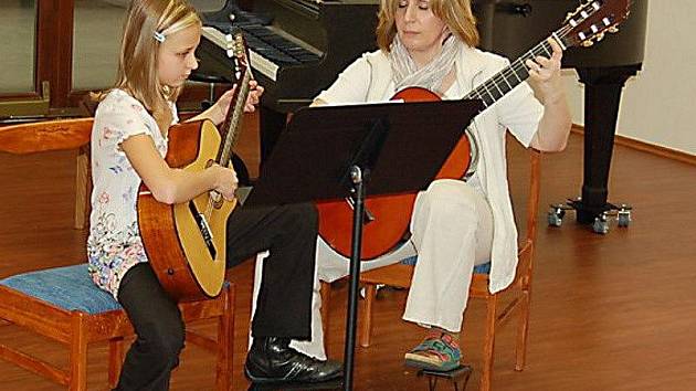 V koncertním sálku ZUŠ se odehrály Vánoční třídní předehrávky žáků ze tříd učitelek Soni Kozákové a Dany Staré. Na snímku jsou právě pedagožka Soňa Kozáková a její šikovná žákyně (kytaristka) Silva Charvátová. 