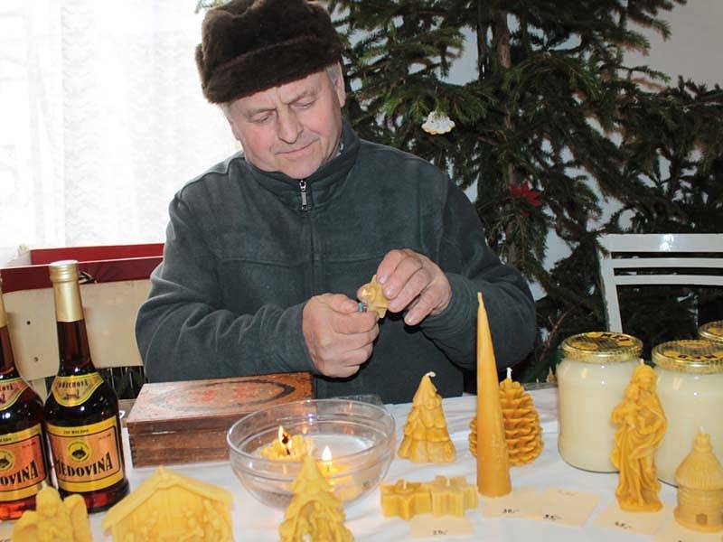 Protipožární zkouška. Včelař Jaroslav Forman převádí, že svíčka ze včelího vosku plave.