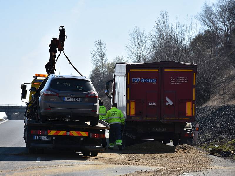 Na dálnici D7 se srazilo osobní auto s nákladním. Řidiče vyprošťovali hasiči.