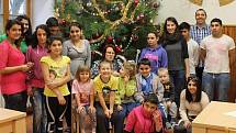 ROMAN PEJŠA (horní řada druhý zprava) s dětmi a kolegyněmi u vánočního stromku v domově v Ledcích.