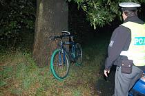 Policista obhlíží kolo zraněného cyklisty. 