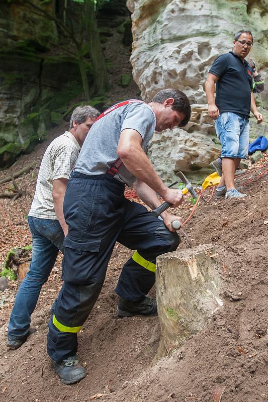 V lese u části Obce Vyskeř - Skalany snaží hasiči a záchranáři již šestým dnem vyprostit psa, který uvízl v liščí noře mezi skalami.