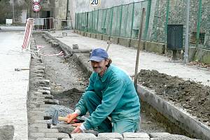 PŘED NOVOHRADSKOU BRÁNOU dokončují pracovníci Lesostaveb Třeboň (na snímku František Schnedörfler) opravy místní komunikace.