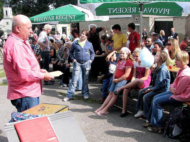 Před hospodou v Políkně bavil hlavně děti u příležitosti 615 let založení obce také kouzelník (vlevo). Z řad diváků si poté také vybíral dobrovolníky, na kterých svá kouzla zkoušel.