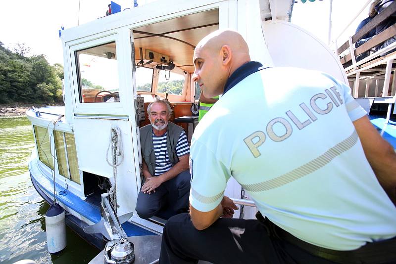 Policisté ze Zvíkovského Podhradí kontrolují lodivody přímo na hladině přehrady.