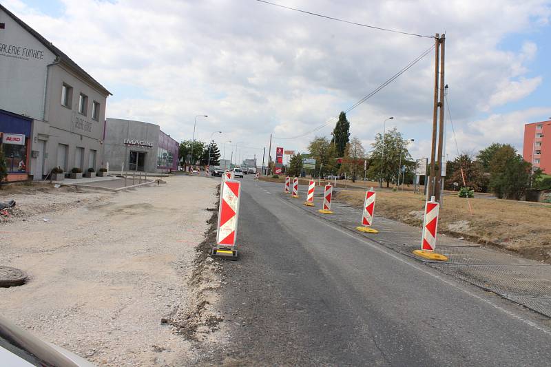 Na silnici v Plzeňské ulici se začal pokládat nový asfalt.