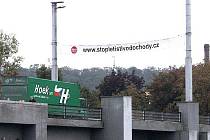 Na kralupském Masarykově mostě visí transparent, vyzývající obyvatele k připojení k petici proti zřízení mezinárodního letiště ve Vodochodech.