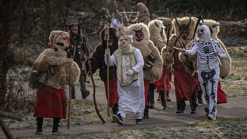 Muži v tradičních čertovských a mikulášských kostýmech procházejí při oslavě svátku sv. Mikuláše 4. prosince 2021 Valašskou Polankou.
