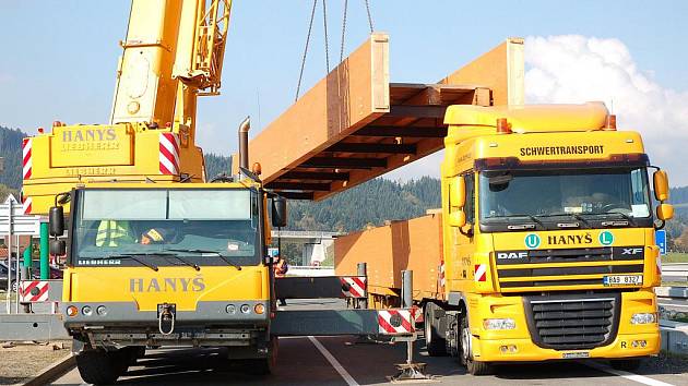 V průmyslové zóně na Bobrkách ve Vsetíně započali dělníci s montáží dřevěné lávky pro pěší, která přemostí čtyřproudou rychlostní silnici I/57