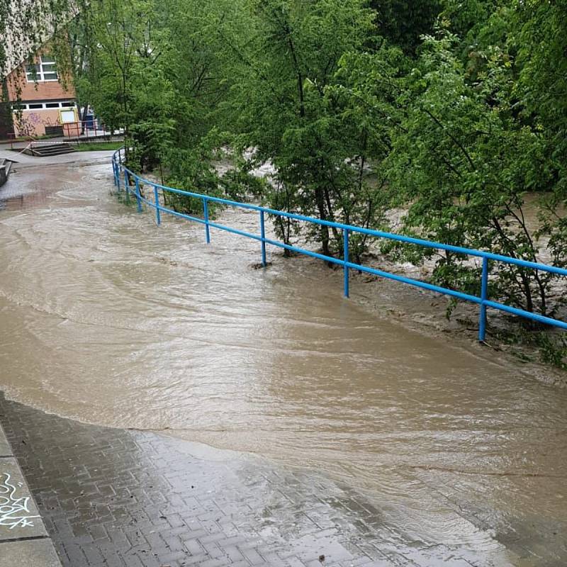 Rozvodněný potok Rokytenka ve vsetínské místní části Rokytnice ve středu 22. května 2019 zaplavil chodníku u zimního stadionu Na Lapači.