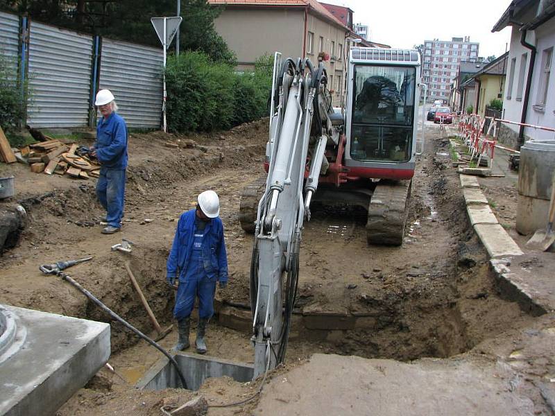 V křižovatce ulice U Cvičišti a Na Hliništi vykopali dělníci poškozenou kanalizaci a v bloku betonu (vpředu) přívod plynu pro nemocnici. Pod hlavní silnicí v křižovatce bylo třeba vyměnit vadné uzávěry.