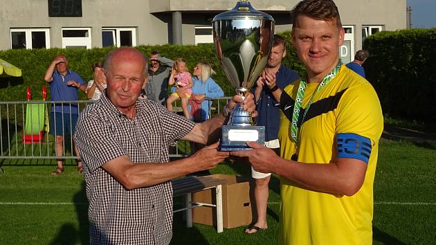 Už třikrát za sebou ovládli krajský pohár fotbalisté Nové Vsi. Takto přebíral vítěznou trofej jejich kapitán Jiří Fuksa (vpravo) po triumfu v sezoně 2021/2022.