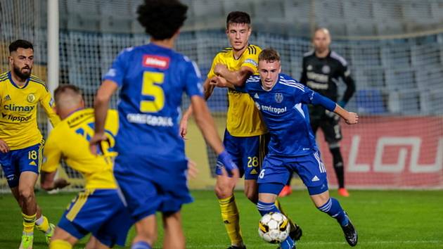 Dorostenec Dominik Farka (na snímku v modrém u míče) se stal plnohodnotným členem kádru druholigového FC Vysočina Jihlava. Na podzim za tým již třikrát nastoupil jako střídající hráč.