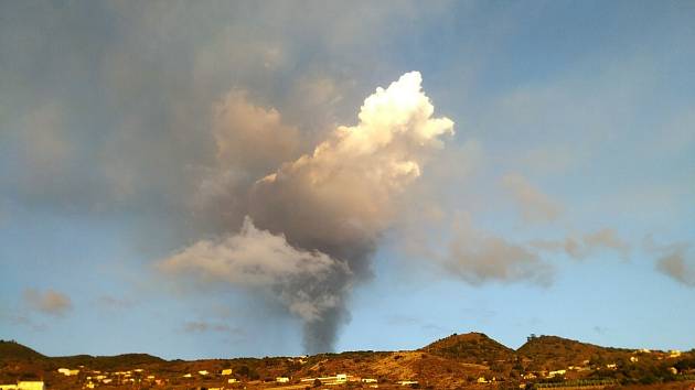 I ze vzdálenosti několika kilometrů je nad horami vidět kouř, který stoupá z vulkánu.