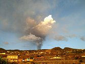 I ze vzdálenosti několika kilometrů je nad horami vidět kouř, který stoupá z vulkánu.