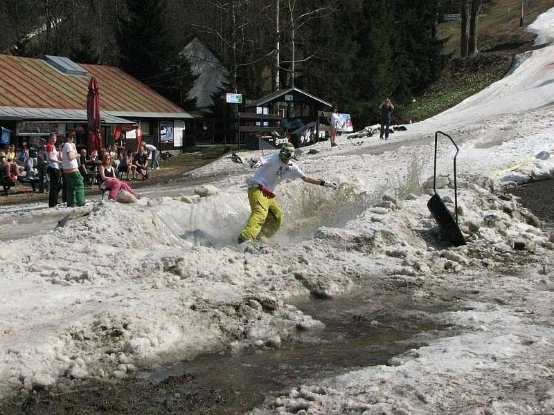 Skákáním přes improvizovaný rybníček se bavili lyžaři a snowboardsité, často i s pomlázkami, na Velikonoční pondělí při posledním lyžování zimní sezony v Deštném v Orlických horách.